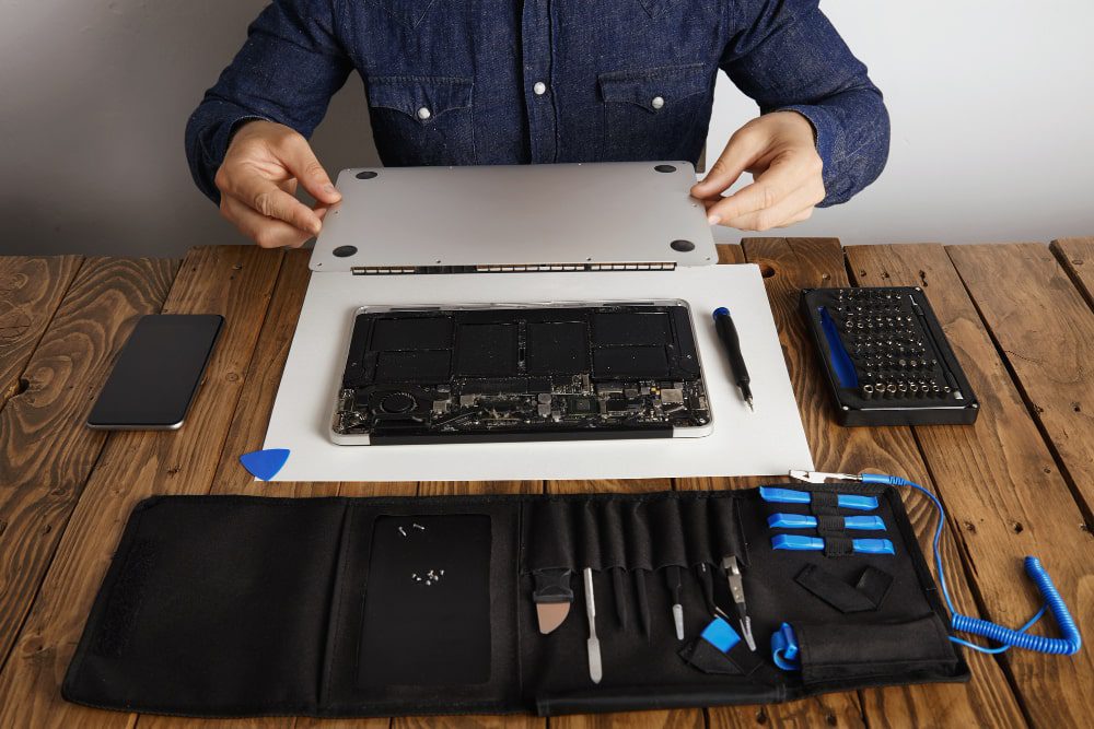 computer technician repairing laptop